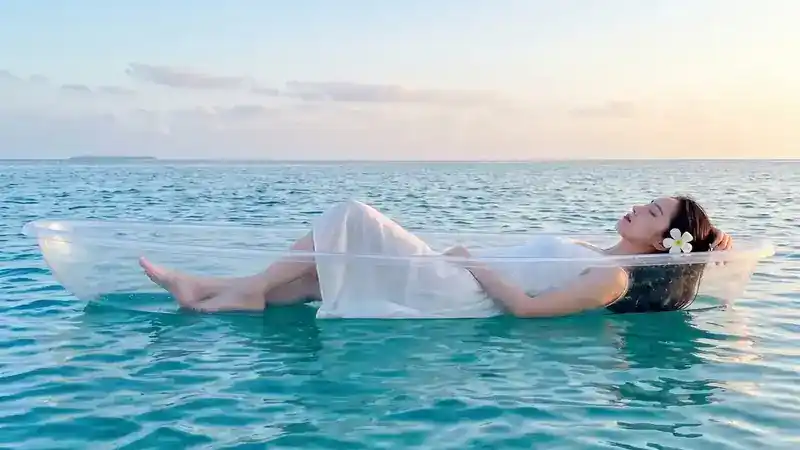 Enjoying a transparent kayak ride through crystal clear waters with Tampi Tampi Resort near Semporna